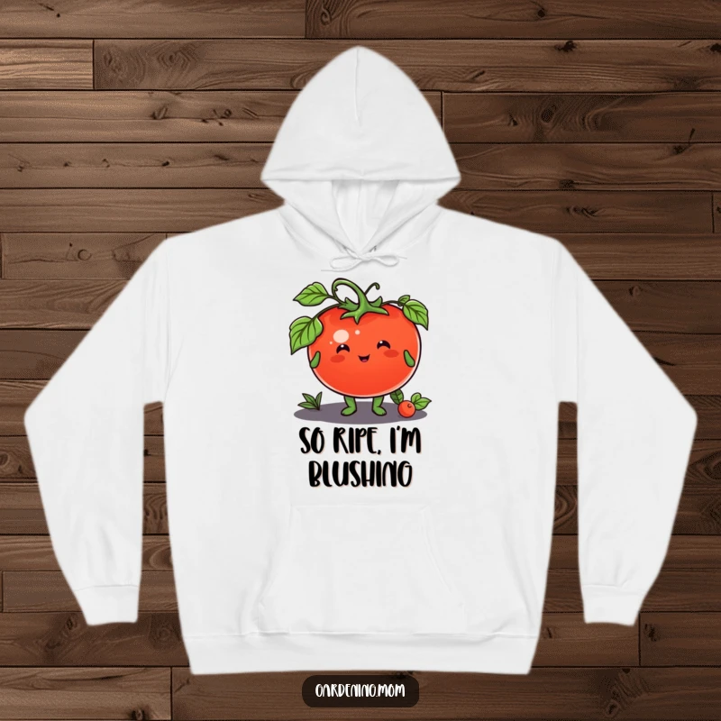 Funny hoodie featuring a happy gardening animal character offering a ripe tomato, perfect for cozy food enthusiasts.